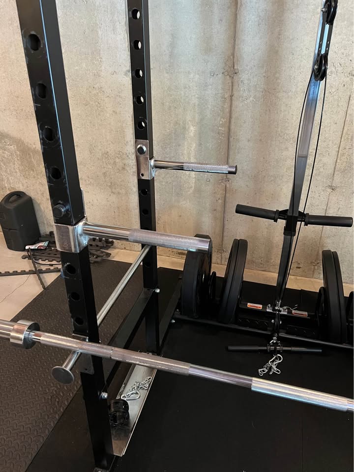 Heavy Duty Power Rack System for Strength Training – All-in-One Home Gym Equipment with Integrated Cable Pulley and Barbell.